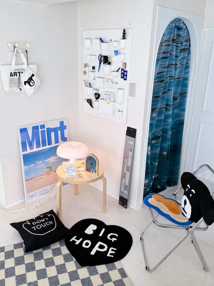 White and blue toned entrance area featuring a side table and wall storage organizer with a simple decor style