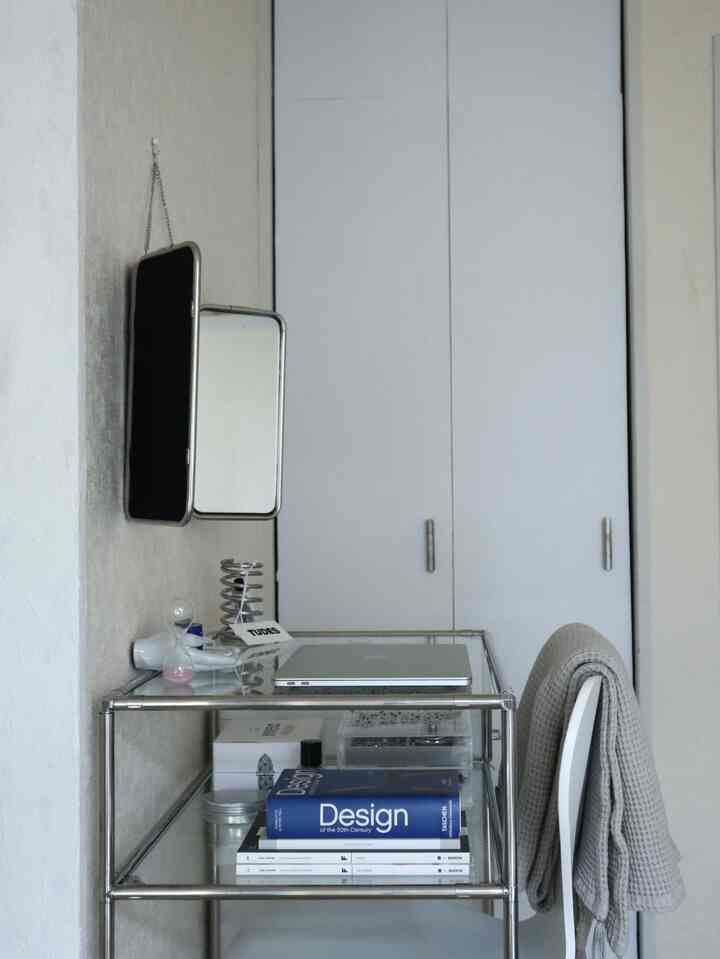 Monotone toned small home office featuring stainless steel vanity and chair in a clean, minimal design