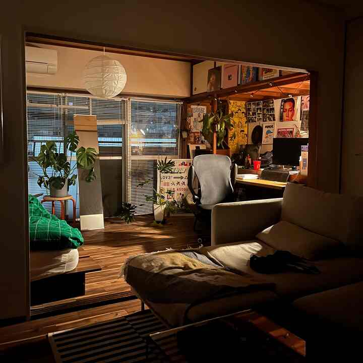 Warm wood tones and white lighting define a compact single household space combining home office and bedroom