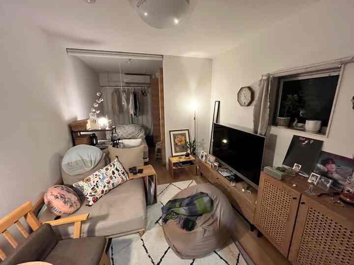 White walls and brown wood-tone furniture in a modern long and narrow living room for a single household