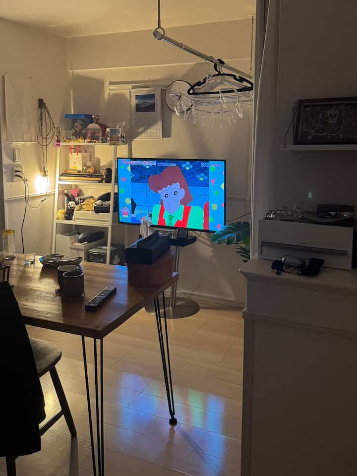 ブラウンの木製テーブルとホワイトの家具が配置された一人暮らしのリビングダイニング、温かみのある落ち着いた雰囲気のインテリア