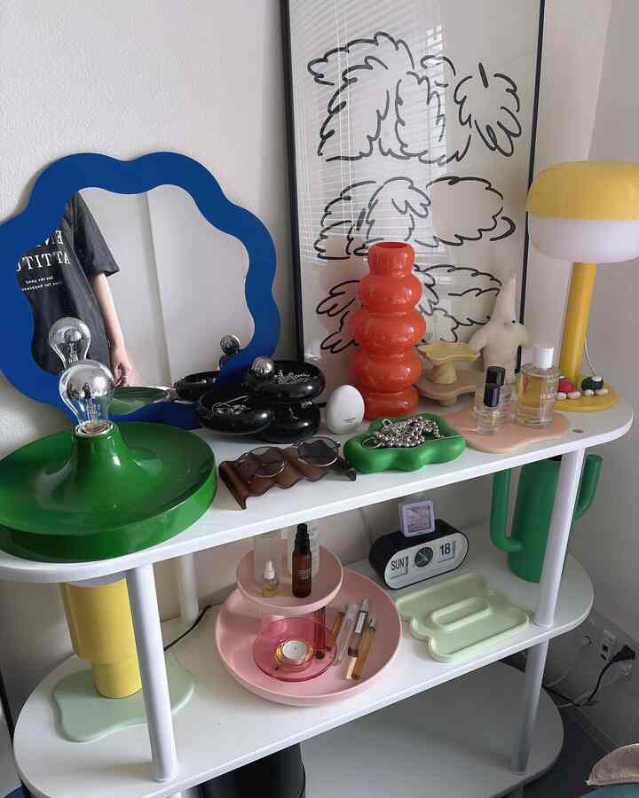 White and green toned single household display rack featuring unique objets and trays in a modern styled space