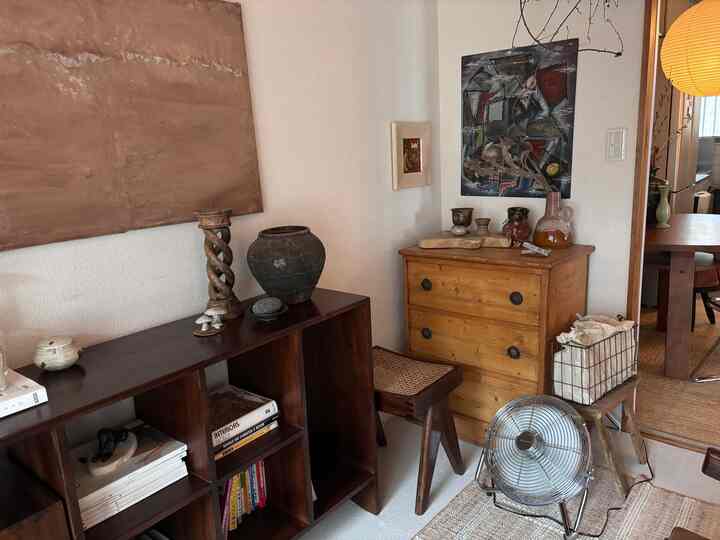 Natural-toned living room featuring vintage objects and wooden furniture in a cozy space