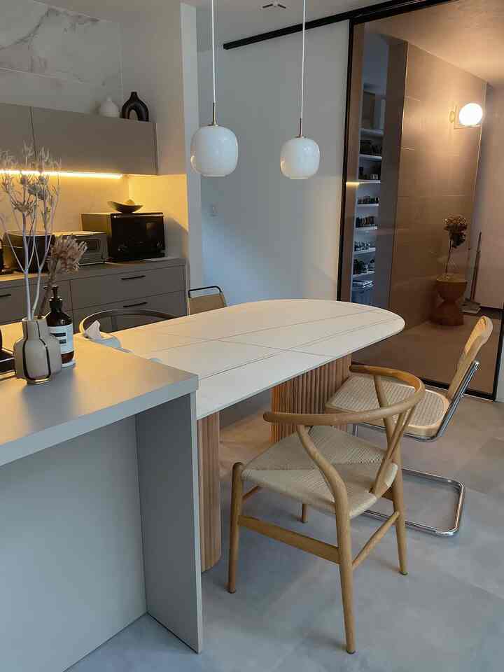 Dining room with natural color and wood tones, featuring a minimal and Japandi style dining table and chairs