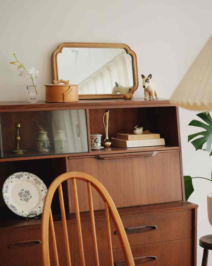Natural wood-tone vintage sideboard and chair arranged in a calm, cozy space