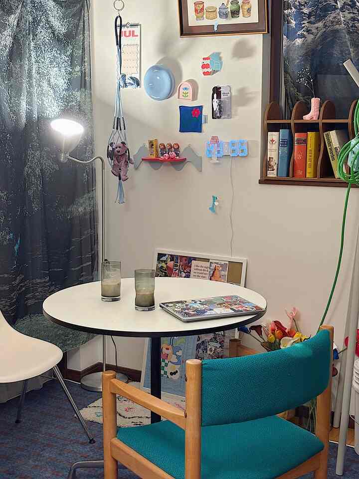 White and blue toned dining room featuring a round dining table and various wall decorations creating a cozy atmosphere