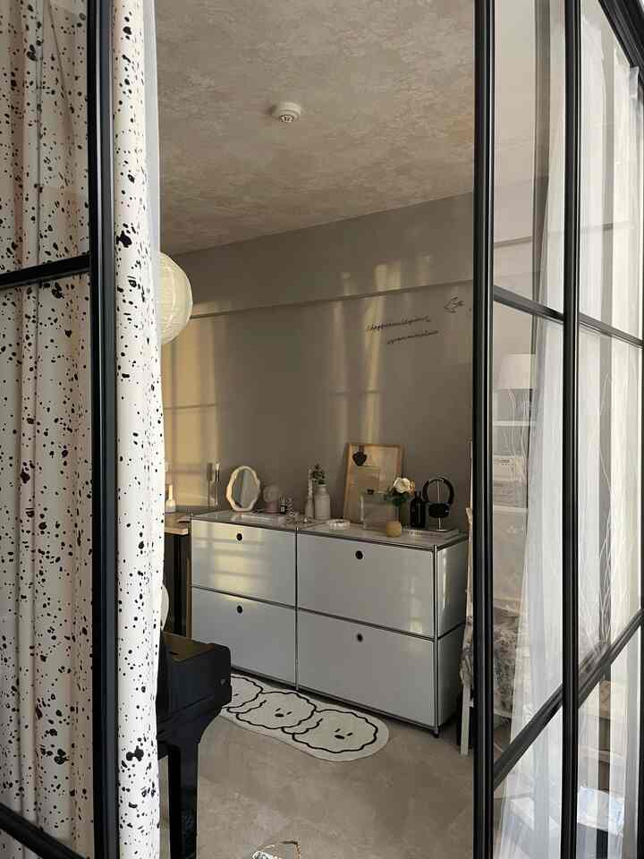 A bright and clean kids' room with gray walls and white modular storage units