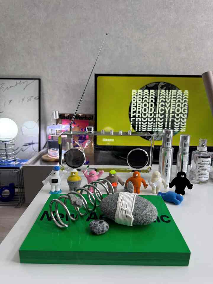 白を基調としたリビング、中央にレトロなラジオとカラフルなフィギュアが配置された雰囲気のあるオブジェ空間