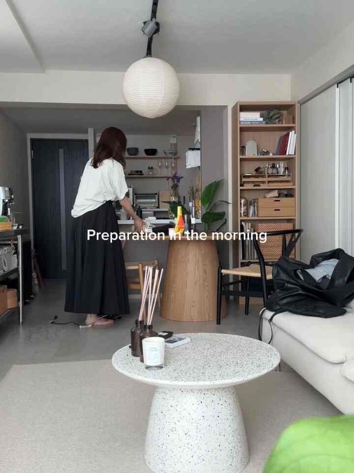 White and wood tone two-person dining room featuring round dining table and sofa with a natural atmosphere