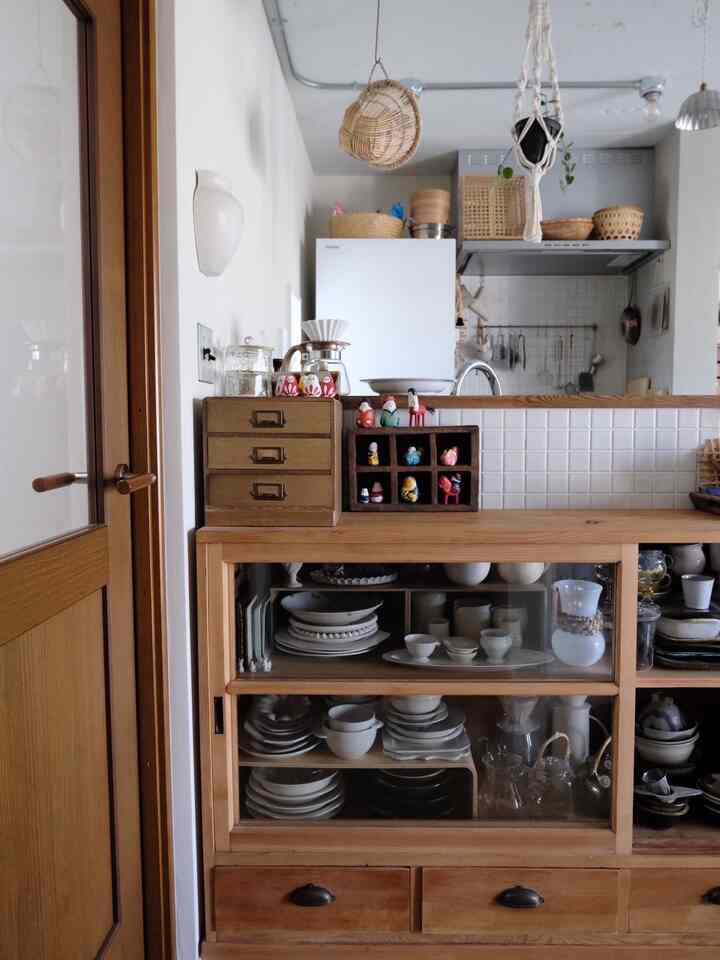 Wood tone and white kitchen space featuring a vintage wooden china cabinet creating a cozy atmosphere