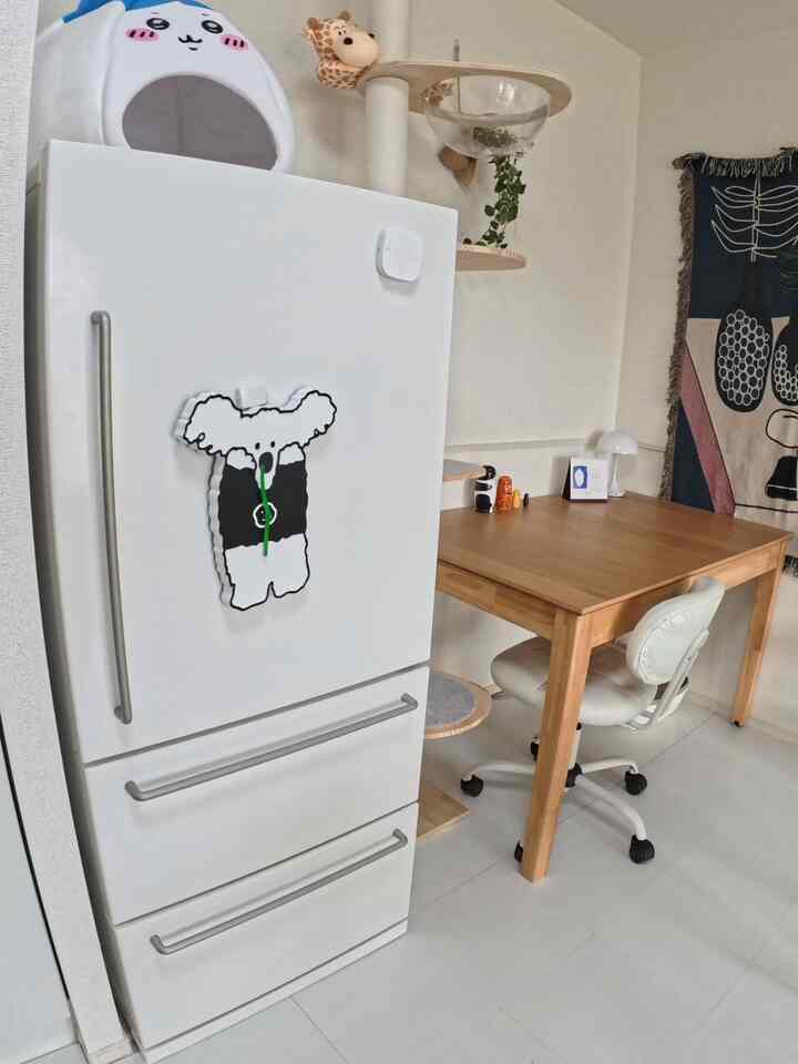 White and wood tone kitchen with home office setup, featuring a cozy two-person space with a visible cat tower