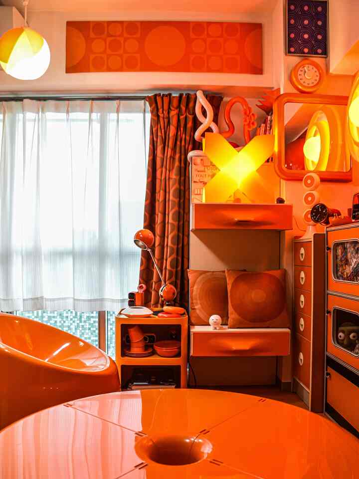 Orange-toned small Showa Retro living room featuring mid-century furniture and various decorative items creating a cozy atmosphere