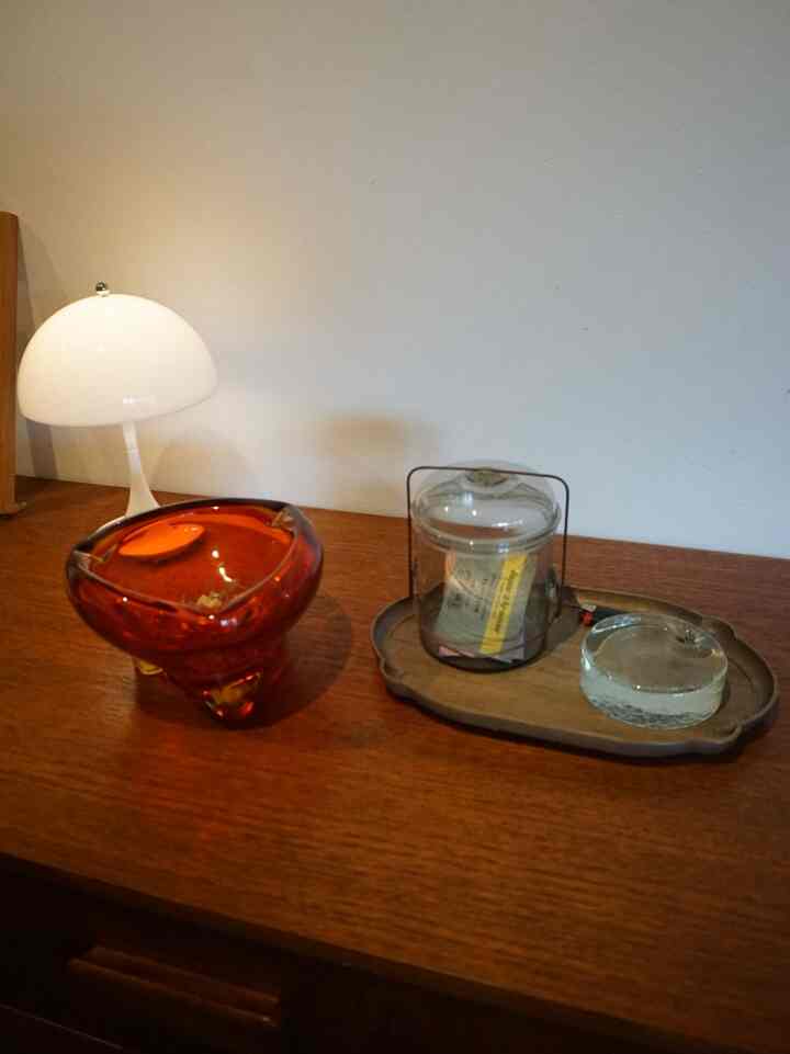 ナチュラルカラーの家具とガラス小物が配置された落ち着いた雰囲気のインテリア