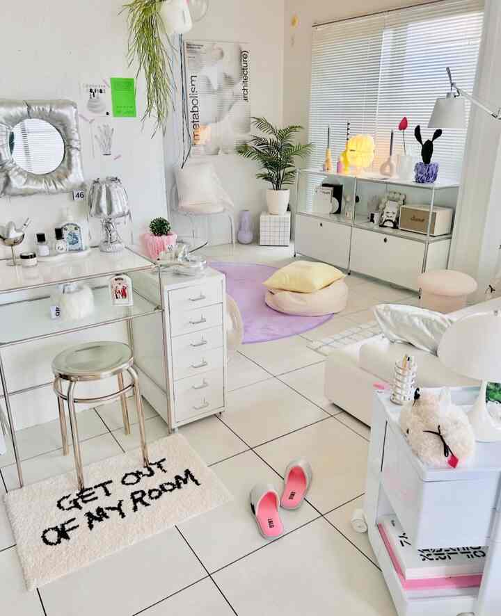 Bright white natural modern home office featuring lavender rug, plants, and clean organized furniture with cozy atmosphere