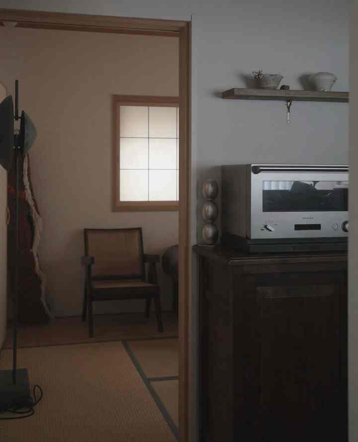 Natural toned kitchen space featuring a BALMUDA oven and wooden furniture with a cozy atmosphere