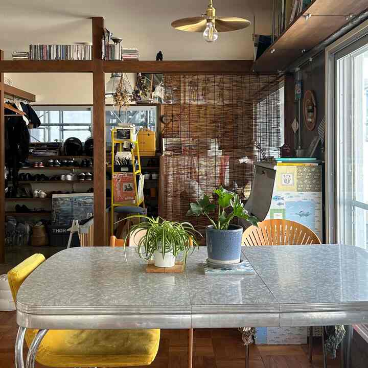 Beige and brown toned dining room featuring vintage dining table and green plants creating a natural atmosphere