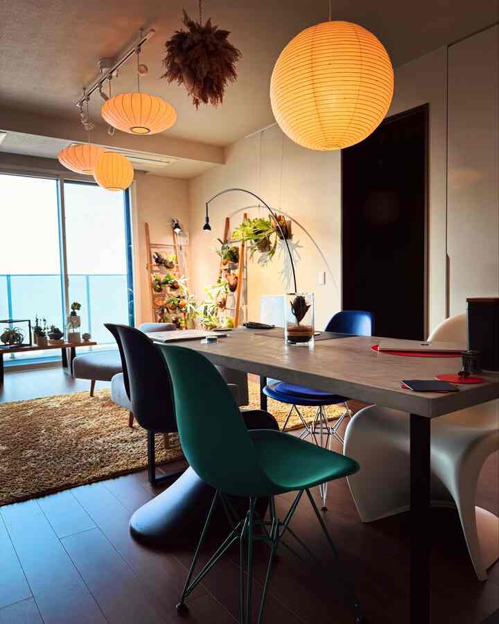 Warm wood tones and mid-century modern living room featuring colorful dining chairs and pendant lighting