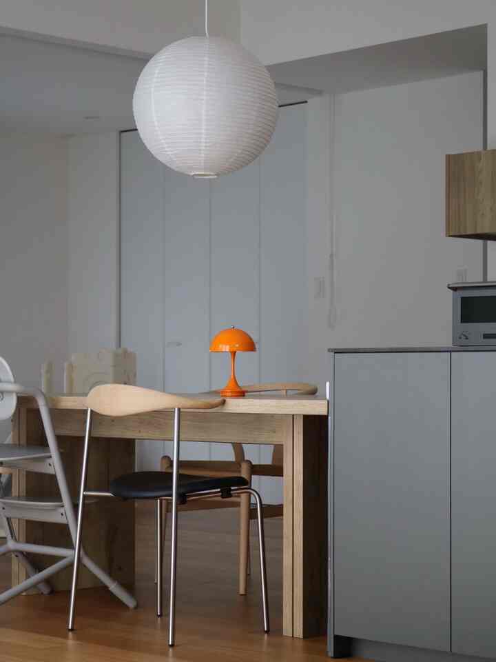 Wood tone dining room featuring a pendant lamp and mid-century modern furniture with a clean atmosphere