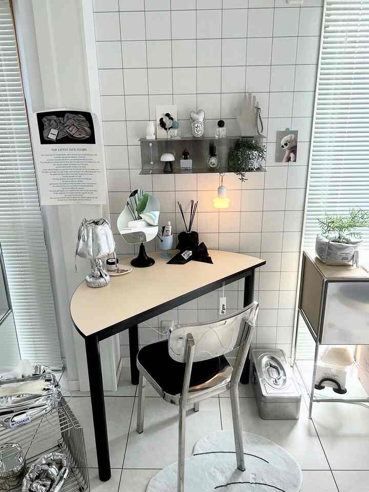 Monotone and silver toned desk space featuring tiled wallpaper and clean, cozy workspace design