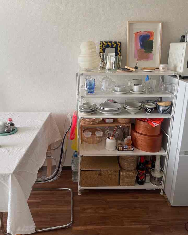 White and brown toned 6-tatami 1K room featuring shelves organized with dishes and storage baskets in a simple interior