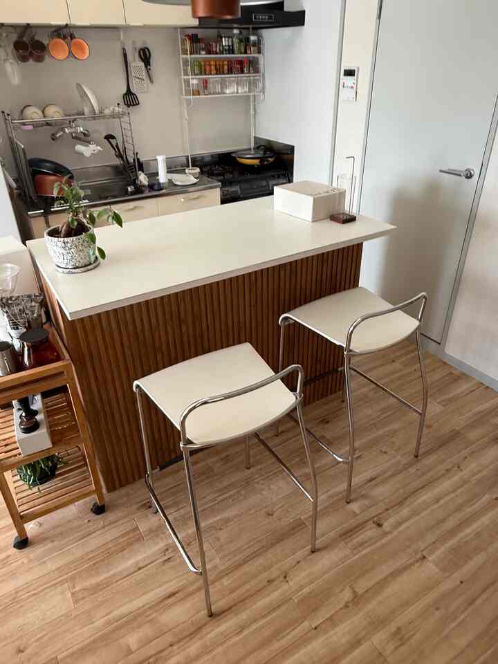 Natural-toned kitchen featuring a counter dining table and bar stools in a cozy two-person space