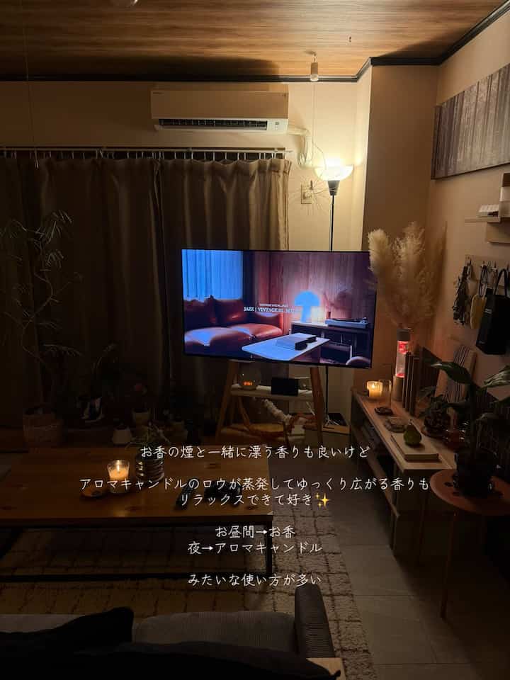 Modern living room with warm brown tones and wooden ceiling, featuring candles and ambient lighting for a cozy atmosphere