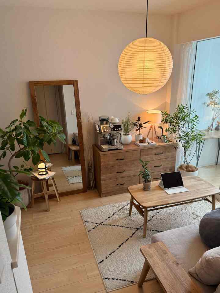 Natural-toned cozy living room featuring wooden furniture and plants in a home cafe setting