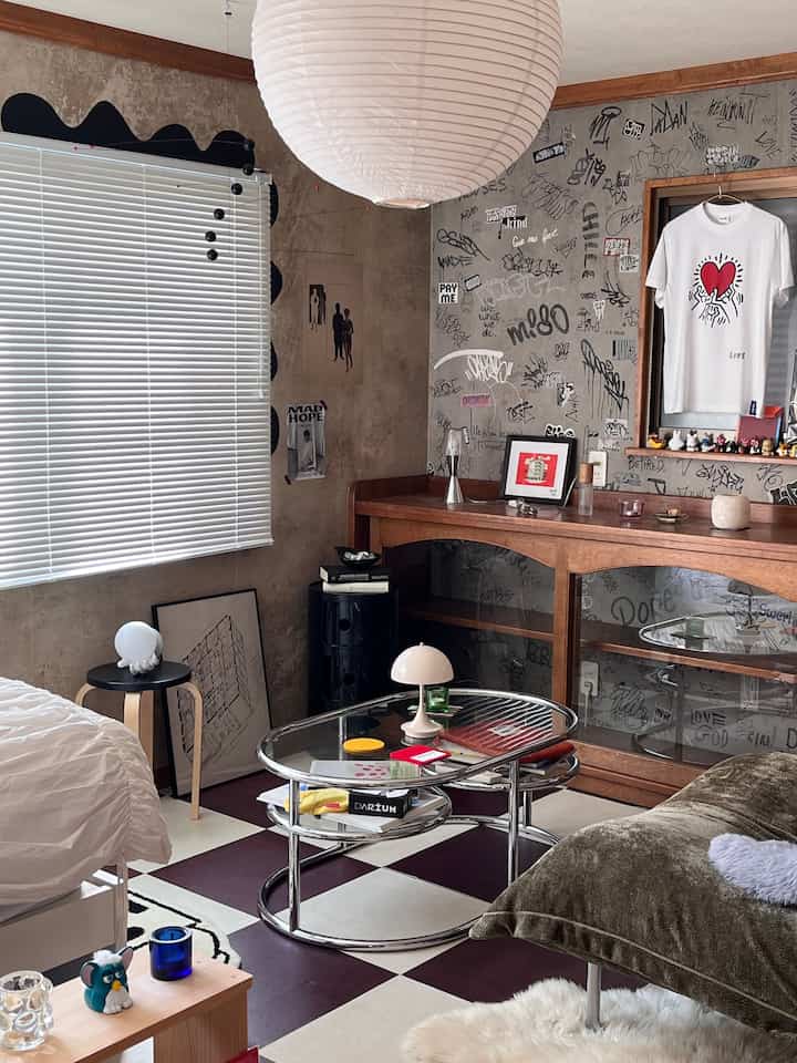 Monotone industrial-inspired single household living room featuring vintage sofa and chrome coffee table with stylish decor