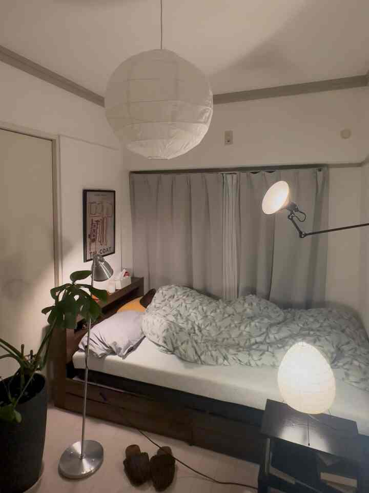 White and wood tone small bedroom featuring indirect lighting and a pendant light creating a cozy atmosphere