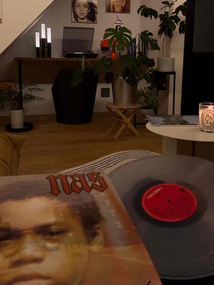 Warm wood-toned living room featuring a record player and candle creating a cozy atmosphere