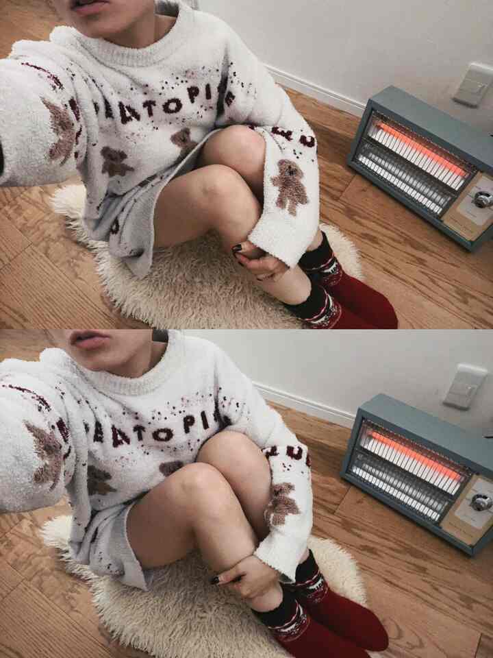 Beige and wood-tone studio apartment featuring a retro electric heater and a cozy person in knitted wear, creating a warm atmosphere