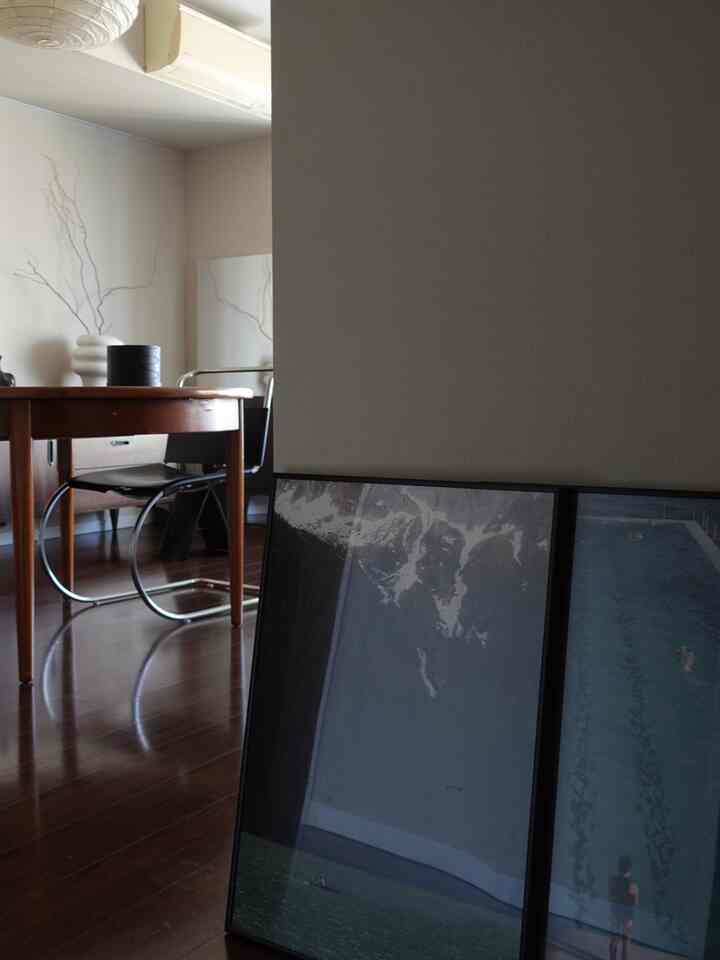 Dark brown wood-toned small dining room featuring a dining table and chairs near the entrance in a modern setting