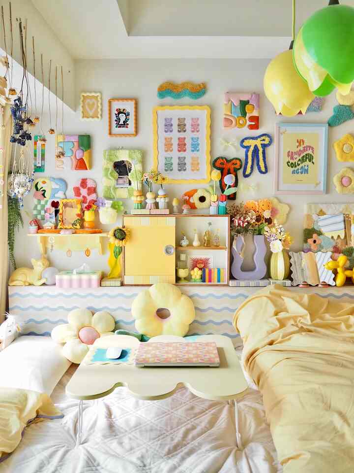 Bright yellow-toned bedroom featuring colorful flower cushions and vibrant wall decor creating a cozy, charming atmosphere