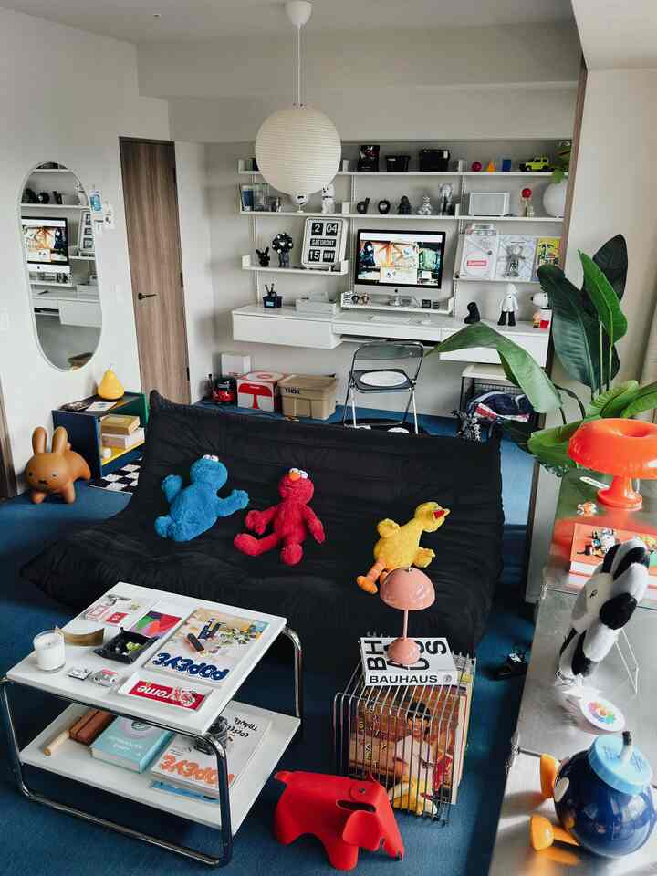 Modern single household living room with black sofa and white desk home office setup