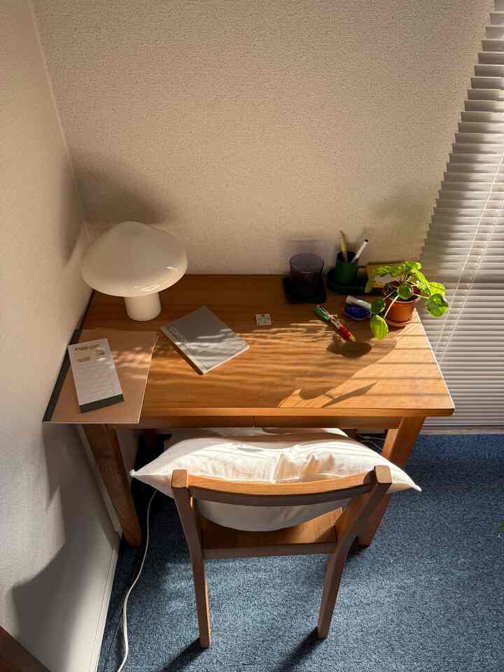 Natural wood tone 6-tatami sized home office featuring a desk with a wireless table lamp and a plant, creating a cozy workspace