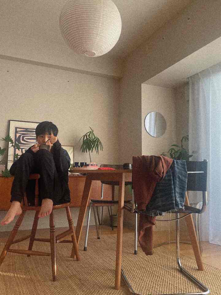 Beige and brown toned dining room featuring mid-century modern dining table and chairs in a cozy home cafe setting