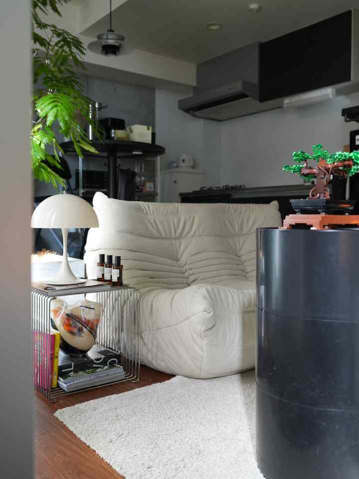 White and dark gray toned living room featuring TOGO loveseat sofa and Pantella mini table lamp with a modern natural interior
