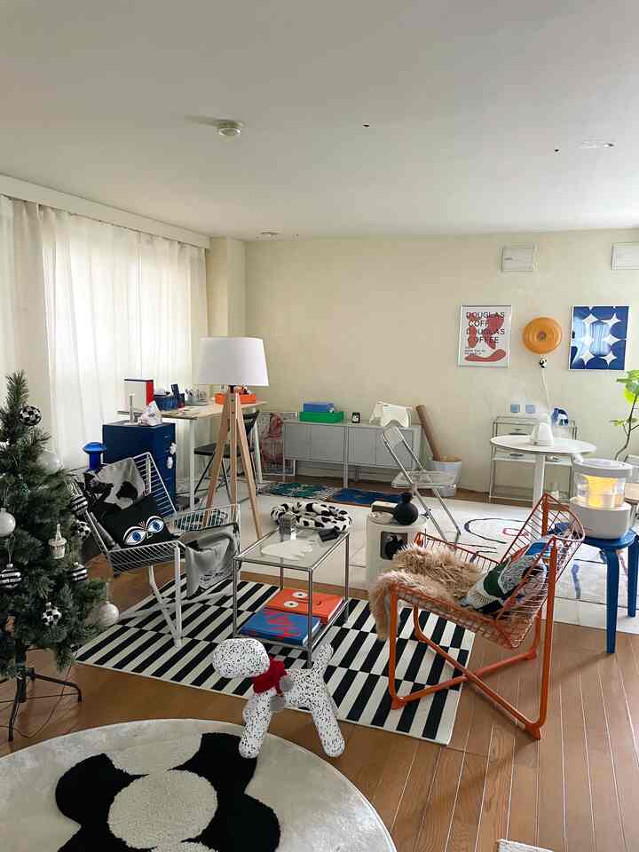 White and black toned two-person living room featuring mid-century modern chairs and a floor lamp creating a cozy atmosphere