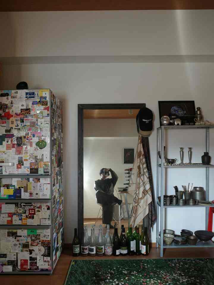 Natural color 1LDK kitchen for a single household featuring a large full-length mirror, refrigerator, metal shelf, and floral rug