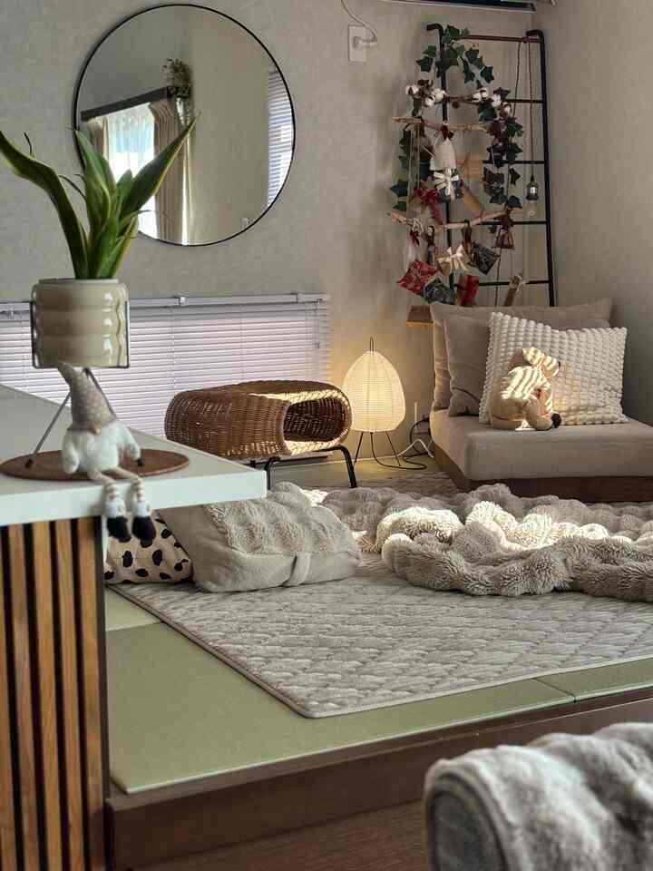 Warm beige toned living room featuring sofa, rattan stool, and cozy textiles creating a natural relaxing atmosphere