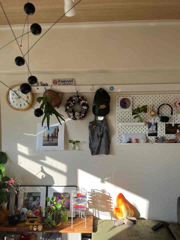 Wood tone and white living room featuring shelves and various small objects creating a cozy atmosphere