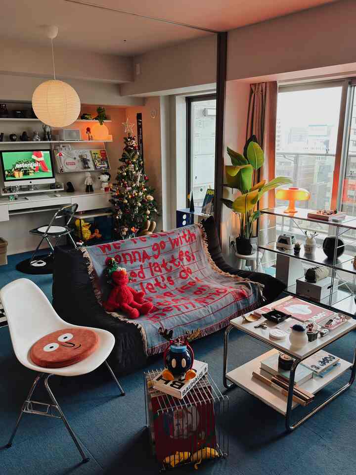 Bright living room with black bean bag sofa and Christmas decorations, blending home office and home cafe elements in a cozy space