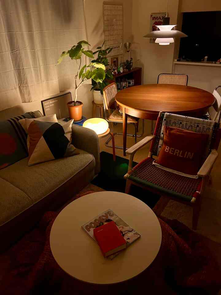 Warm wood tones and natural elements in a living room featuring mid-century modern furniture and pendant lighting creating a cozy atmosphere