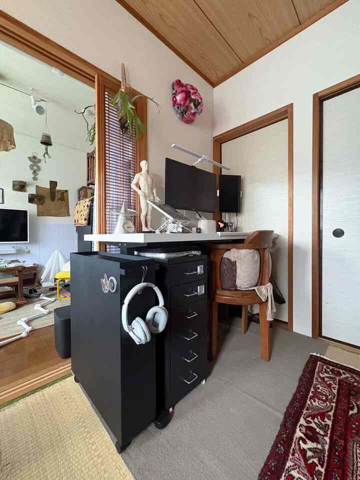 Natural compact study space in black and white tones, featuring a desk and storage cabinet arranged neatly for remote work