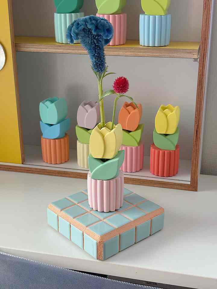 Pastel-toned flower vase and tile tray arranged as charming home decor piece