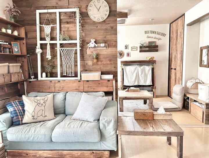 ナチュラルな色調と木目調が調和したリビング、淡い青色のソファと畳の空間が落ち着いた雰囲気を醸し出している