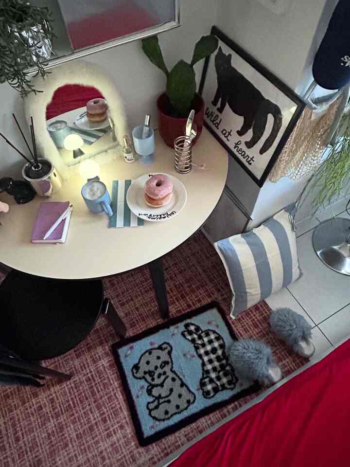 Blue and black toned bedroom featuring a cute animal motif rug and a small round table creating a cozy interior