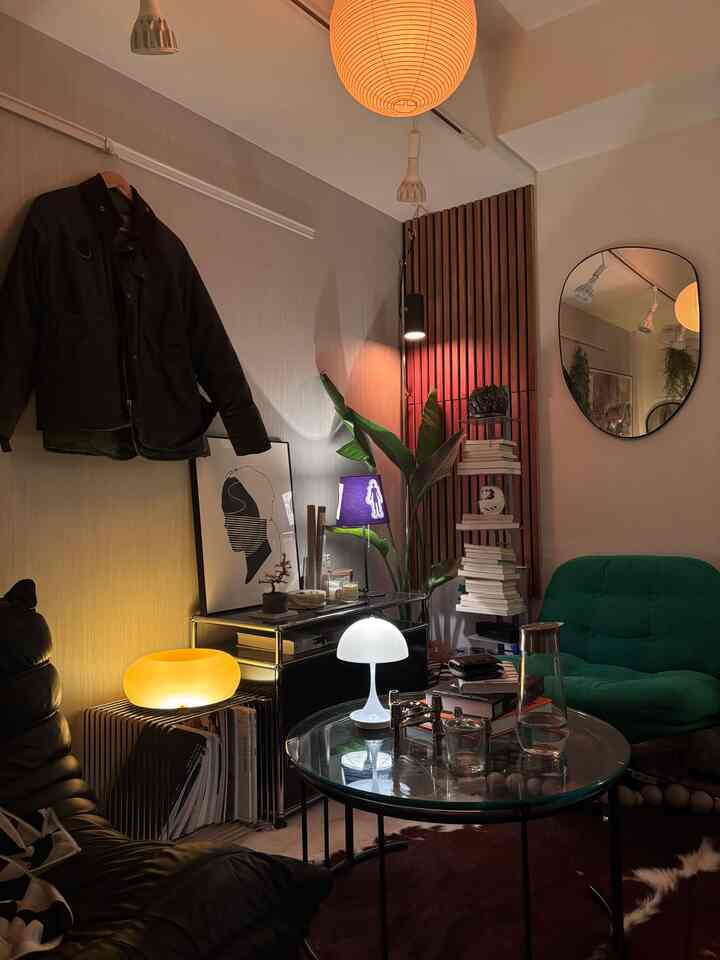 Cozy 8-tatami single household living room with warm lighting and a green armchair