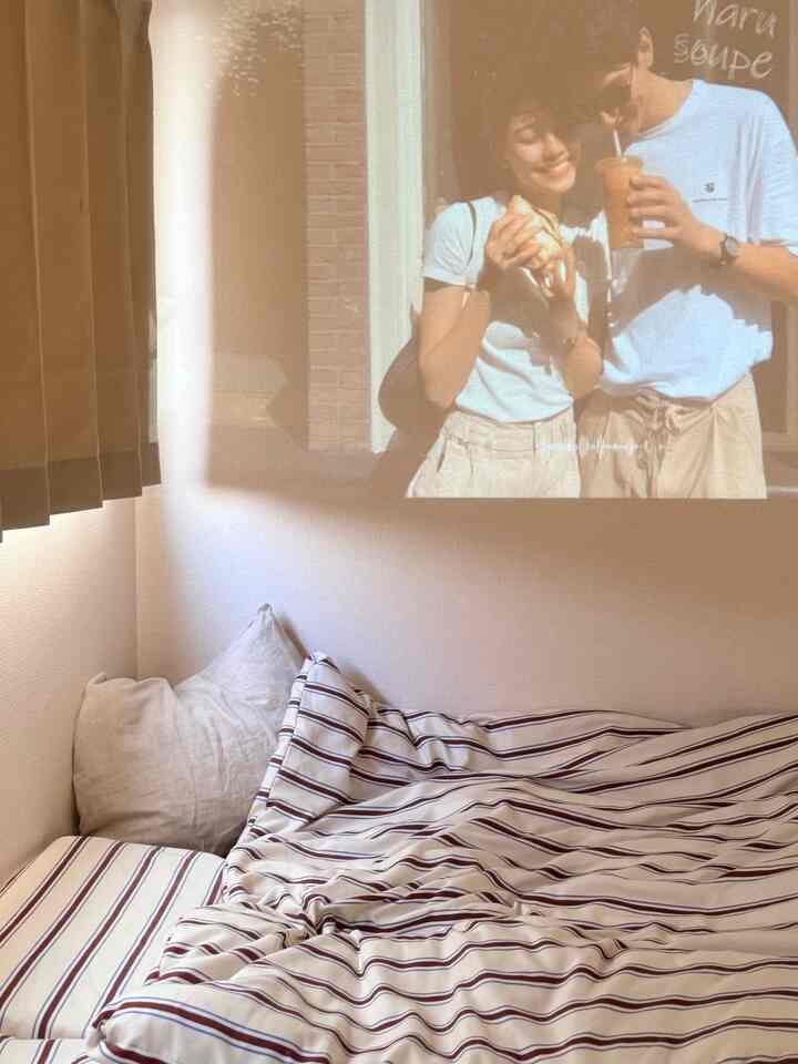 Natural beige-toned bedroom featuring striped duvet cover and pillows with a cozy atmosphere