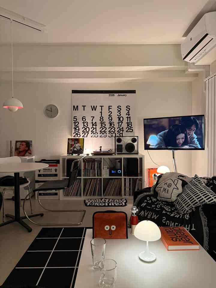 Monotone living room featuring black sofa and white coffee table with a minimalist and modern atmosphere